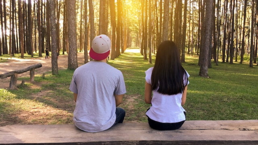 couple on bench in woods