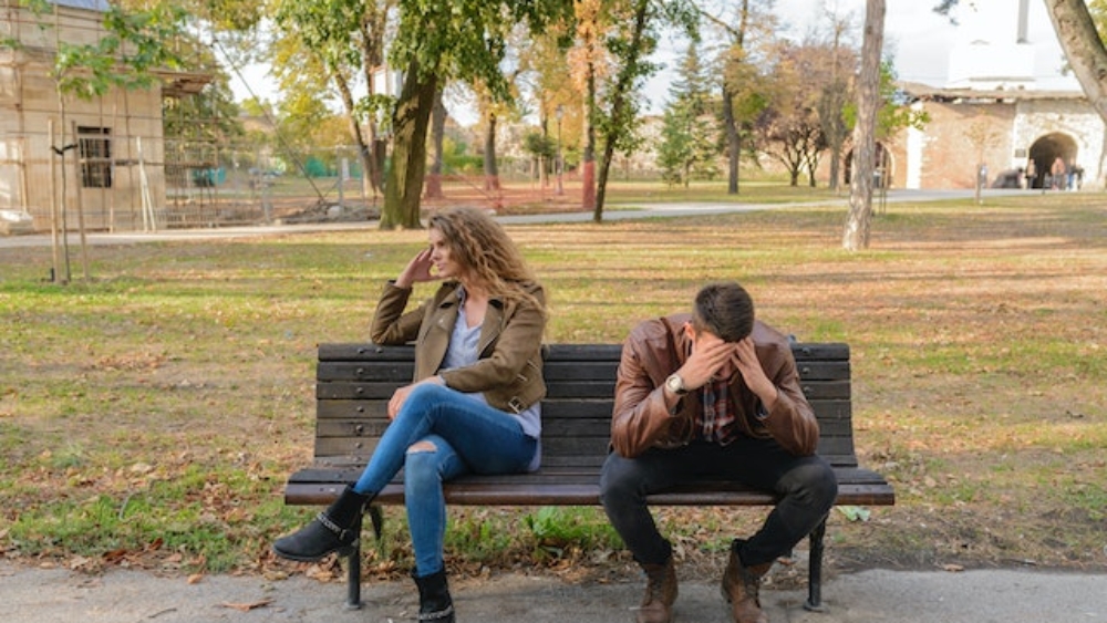 couple sitting on bench who are upset with one another